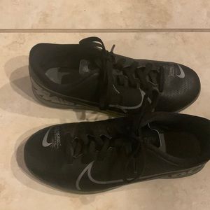 Nike merc 7s, size four in kids. Color black and gray